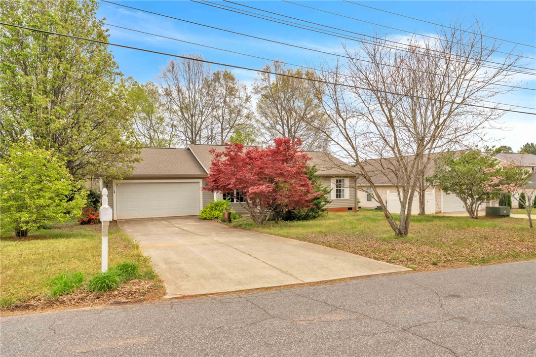 This charming home offers convenient parking and lush and colorful landscaping.