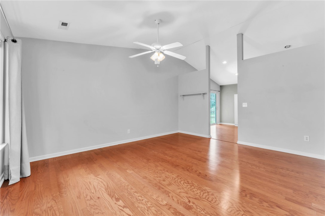 1816 Marchbanks Avenue Anderson, SC 29621 - Photo 5 of 31 This living area features gleaming floors and high vaulted ceilings, offering a spacious and bright atmosphere.