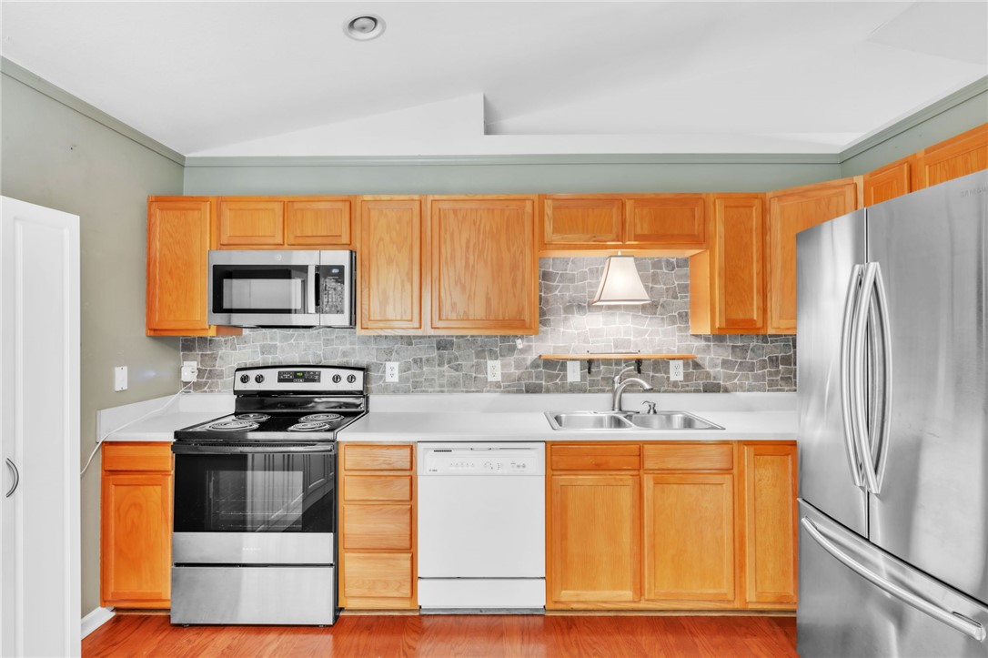 1816 Marchbanks Avenue Anderson, SC 29621 - Photo 8 of 31 This updated kitchen features warm wood cabinetry, some stainless steel appliances, and sleek countertops.