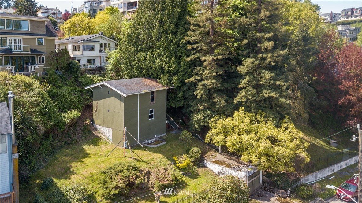 1701 41st Avenue Southwest Seattle, WA 98116 - Photo 11 of 21 a aerial view of a house with a yard and large trees