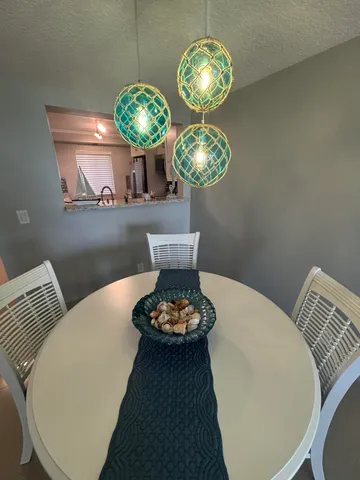 a view of a dining room with furniture and chandelier