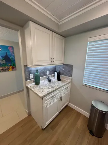 a kitchen with stainless steel appliances granite countertop a refrigerator stove and sink