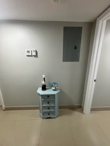 a bedroom with a bed and large windows