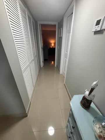 a bathroom with a granite countertop sink a mirror and shower