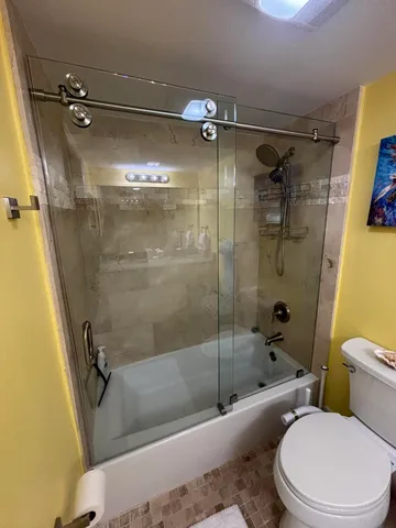 a bathroom with a sink mirror vanity and toilet