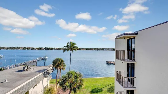 a view of a lake with couches in front of it