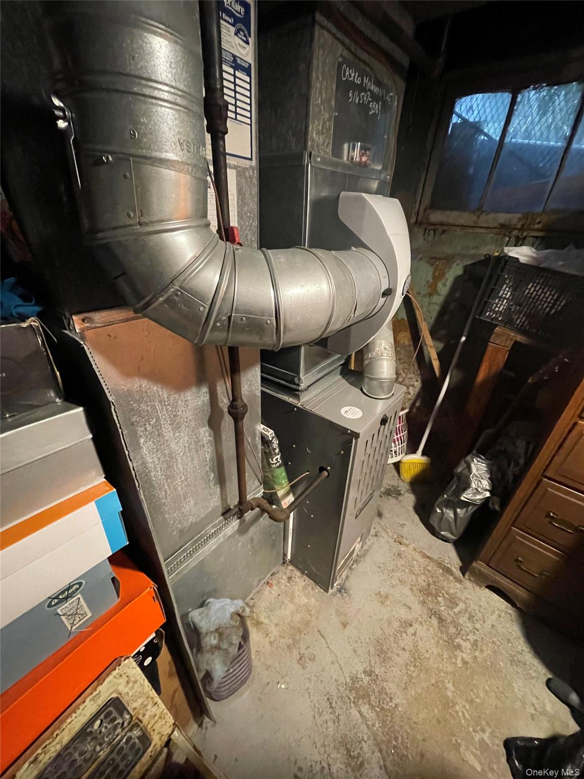 106-20 109th Avenue Queens, NY 11417 - Photo 11 of 12 Basement view of heating unit and unfinished concrete floors