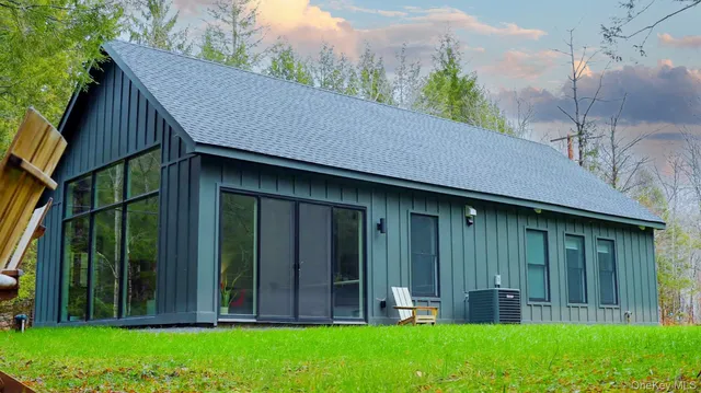 a view of backyard with potted plants and wooden fence