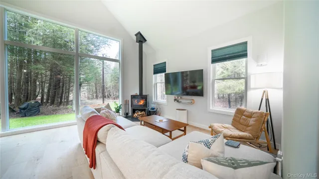 a dining room with furniture a window and kitchen view