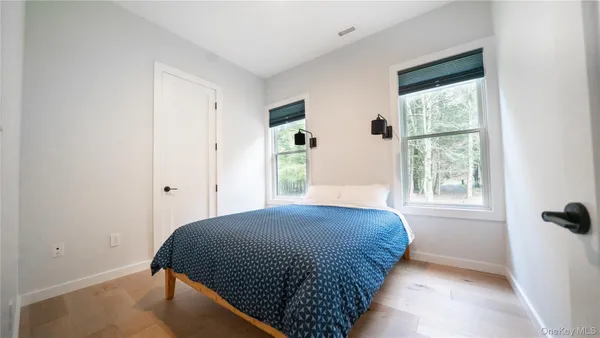 a living room with furniture a flat screen tv and a large window