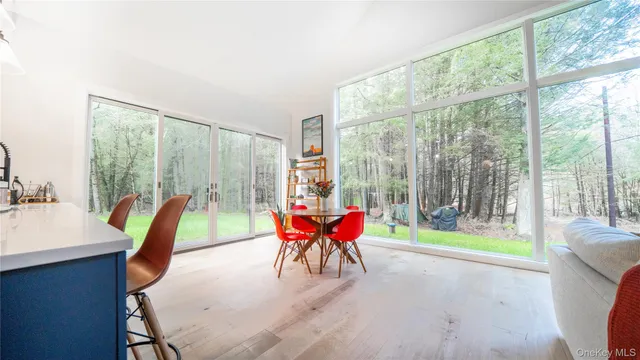 a kitchen with stainless steel appliances granite countertop a refrigerator a sink dishwasher a stove and white countertops with wooden floor