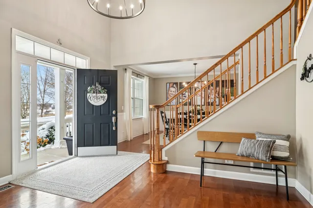 a living room with furniture a baby crib and a window