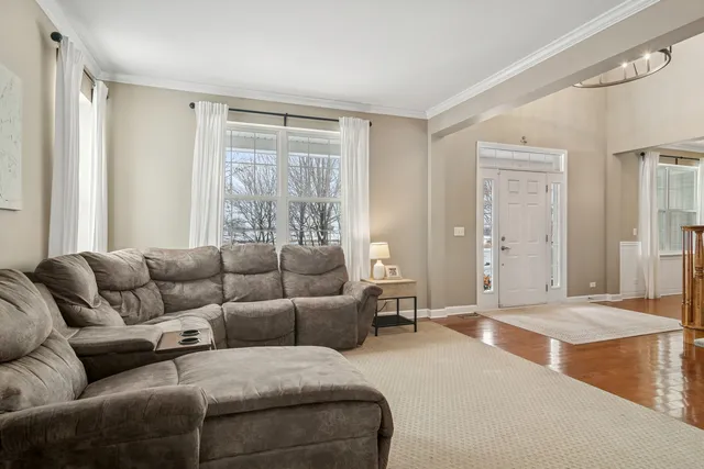 a view of a a dining room with furniture window and wooden floor
