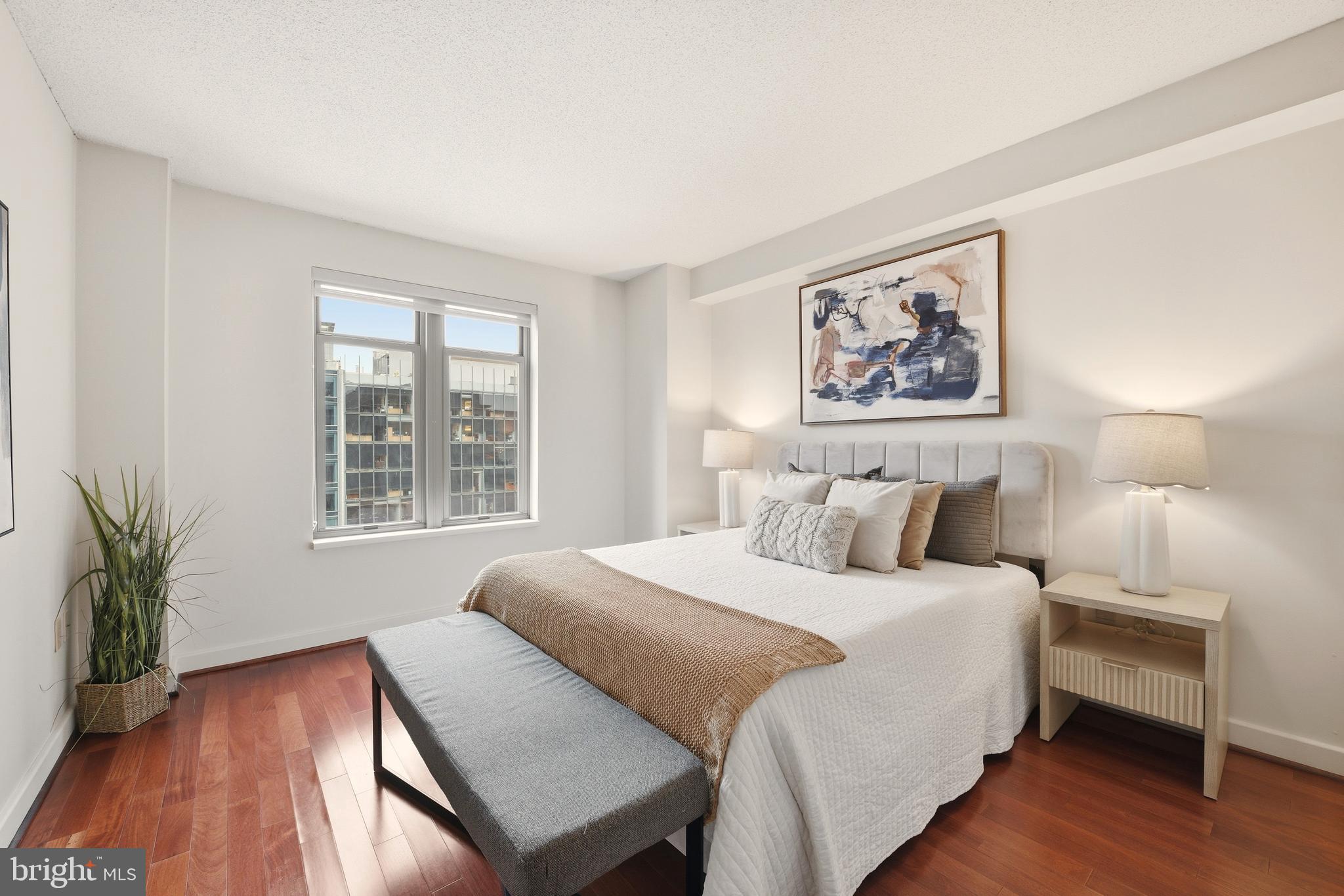 1150 K Street Northwest, Unit 1109 Washington, DC 20005 - Photo 12 of 33 a bedroom with a bed and a wooden floor