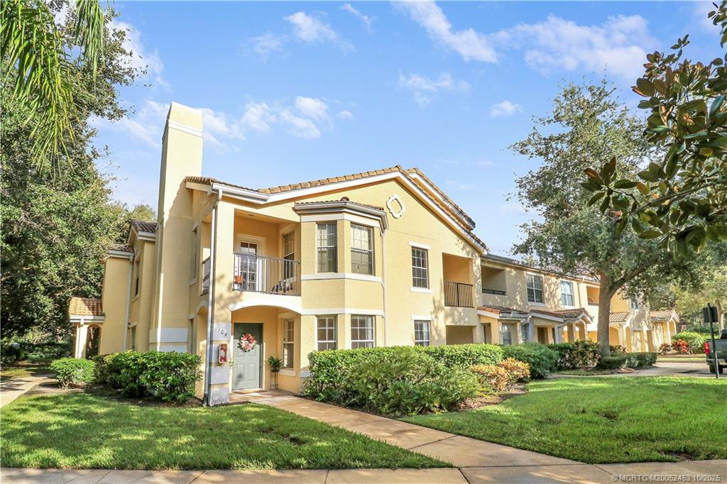 110 Southwest Peacock Boulevard, Unit 6104 Port St. Lucie, FL 34986 - Photo 1 of 27 a front view of a house with a yard