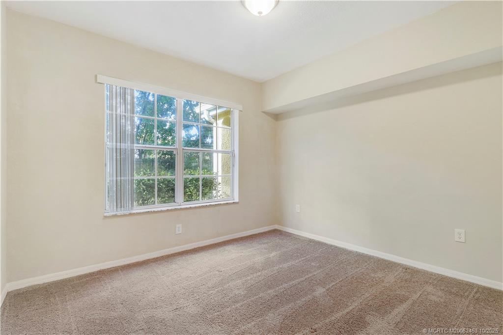 110 Southwest Peacock Boulevard, Unit 6104 Port St. Lucie, FL 34986 - Photo 19 of 27 an empty room with a window
