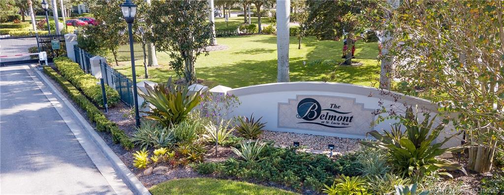 110 Southwest Peacock Boulevard, Unit 6104 Port St. Lucie, FL 34986 - Photo 26 of 27 a sign that is sitting on a wooden fence