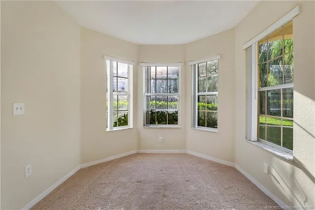 an empty room with windows and closet