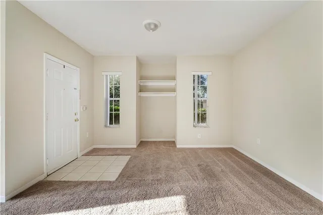 a view of kitchen with stainless steel appliances granite countertop a stove and a sink with cabinets