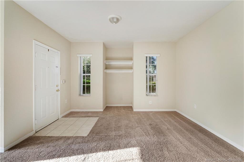 110 Southwest Peacock Boulevard, Unit 6104 Port St. Lucie, FL 34986 - Photo 7 of 27 an empty room with windows and closet