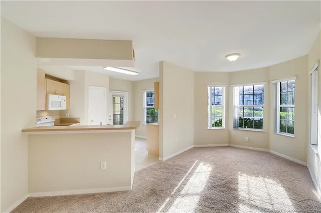 a kitchen with a refrigerator cabinets and a wooden floor