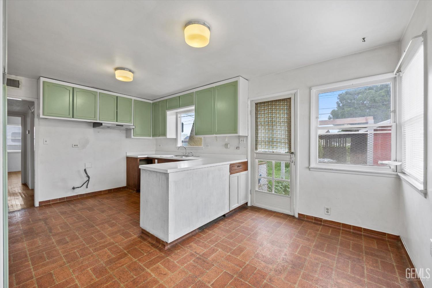 Undisclosed Address Bakersfield, CA 93308 - Photo 11 of 50 a kitchen with a sink and cabinets