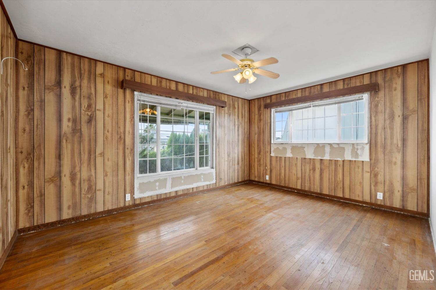 Undisclosed Address Bakersfield, CA 93308 - Photo 19 of 50 a view of an empty room with a window and wooden floor
