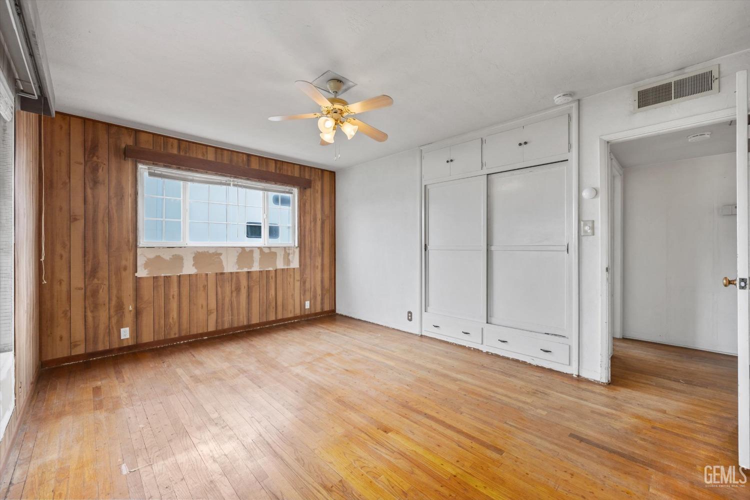 Undisclosed Address Bakersfield, CA 93308 - Photo 20 of 50 a view of an empty room with wooden floor and a window