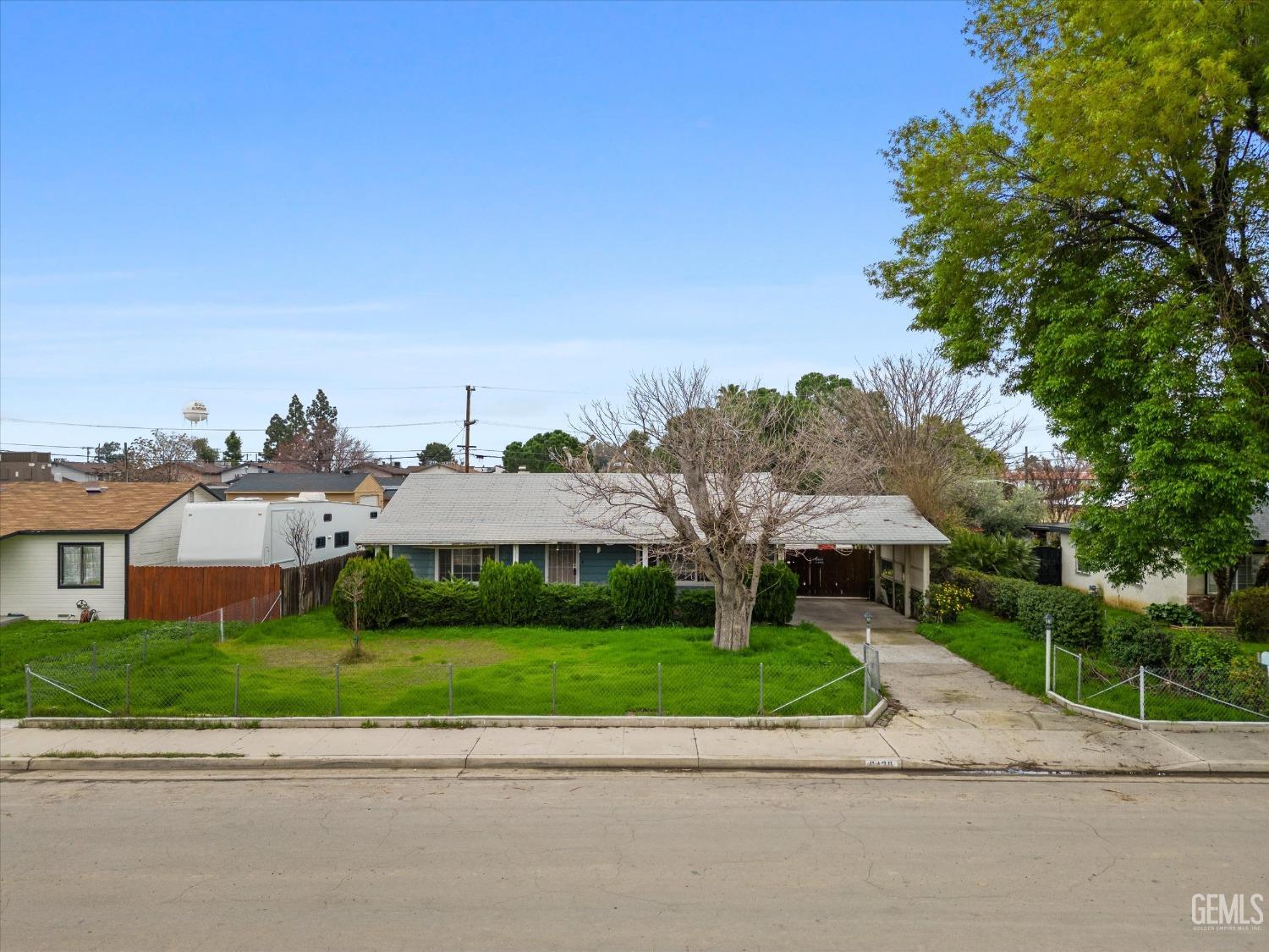 Undisclosed Address Bakersfield, CA 93308 - Photo 2 of 50 a view of a house with a yard and potted plants