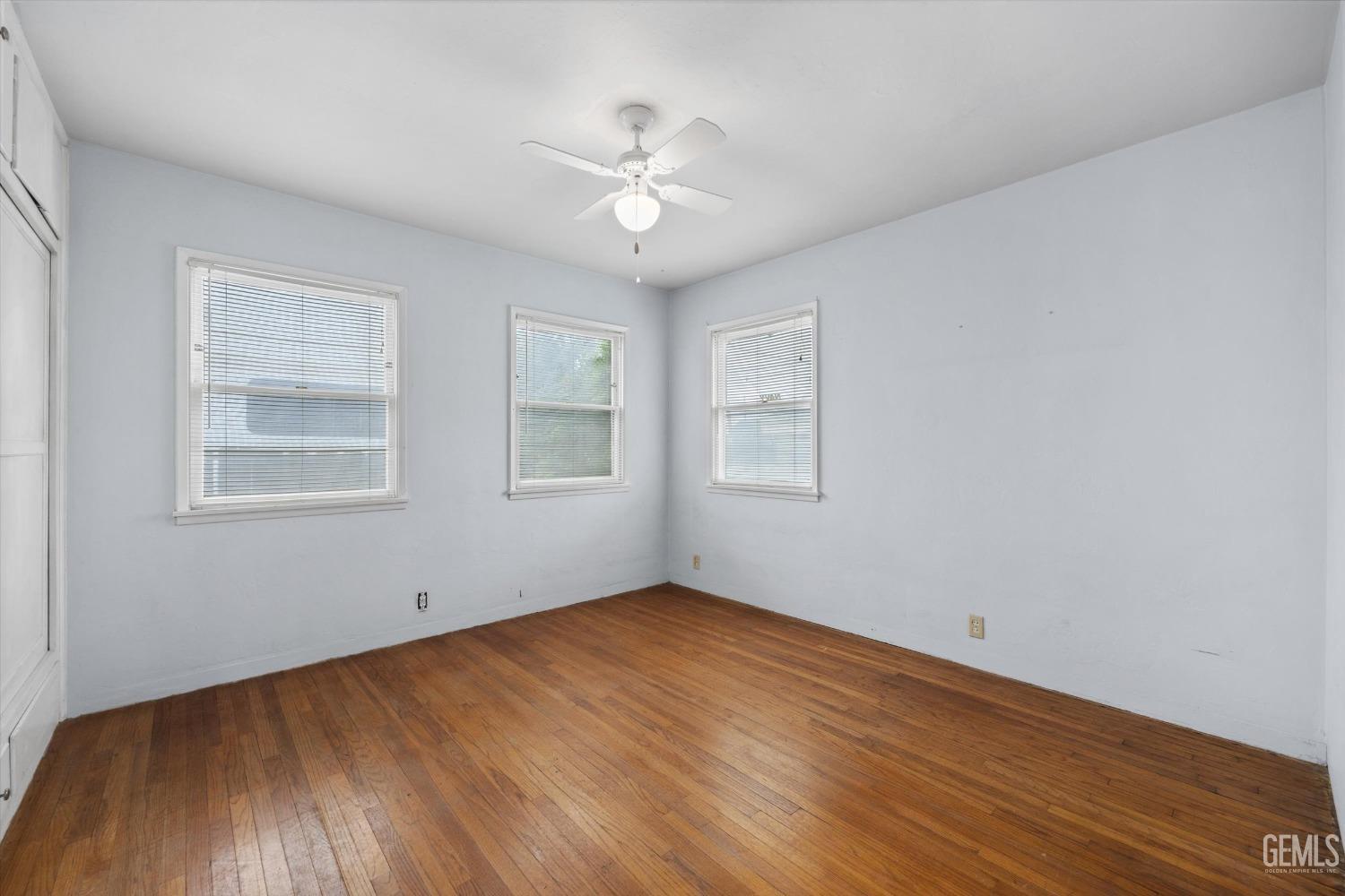 Undisclosed Address Bakersfield, CA 93308 - Photo 21 of 50 a view of an empty room with wooden floor and a window