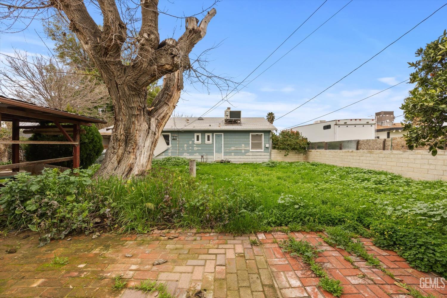 Undisclosed Address Bakersfield, CA 93308 - Photo 24 of 50 a view of a house with a yard
