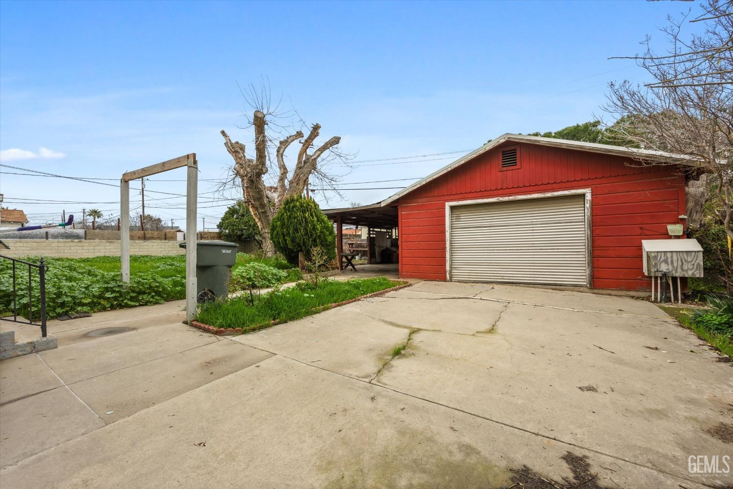 Undisclosed Address Bakersfield, CA 93308 - Photo 26 of 50 a front view of a house with a yard and garage