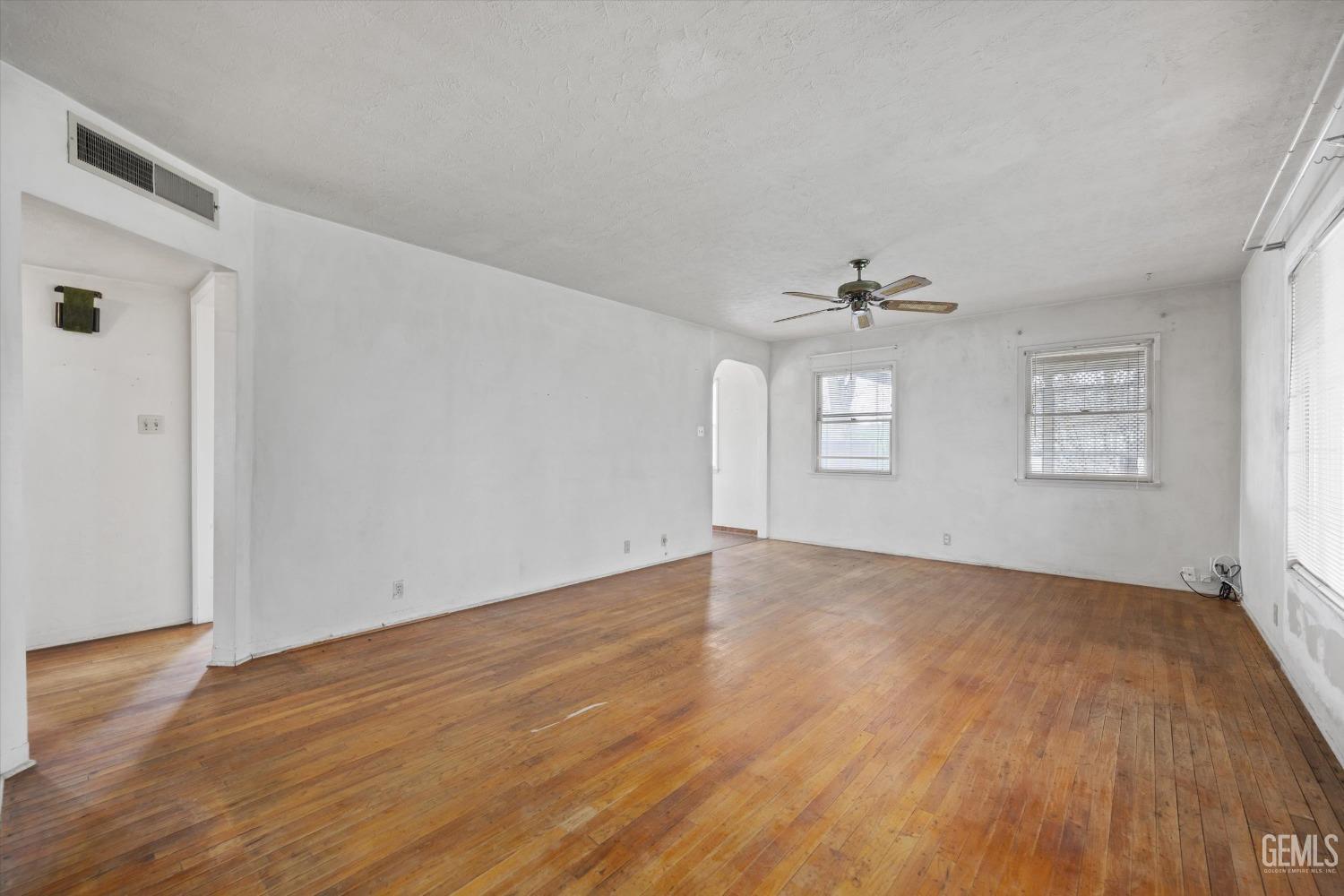 Undisclosed Address Bakersfield, CA 93308 - Photo 7 of 50 a view of an empty room with wooden floor and a window