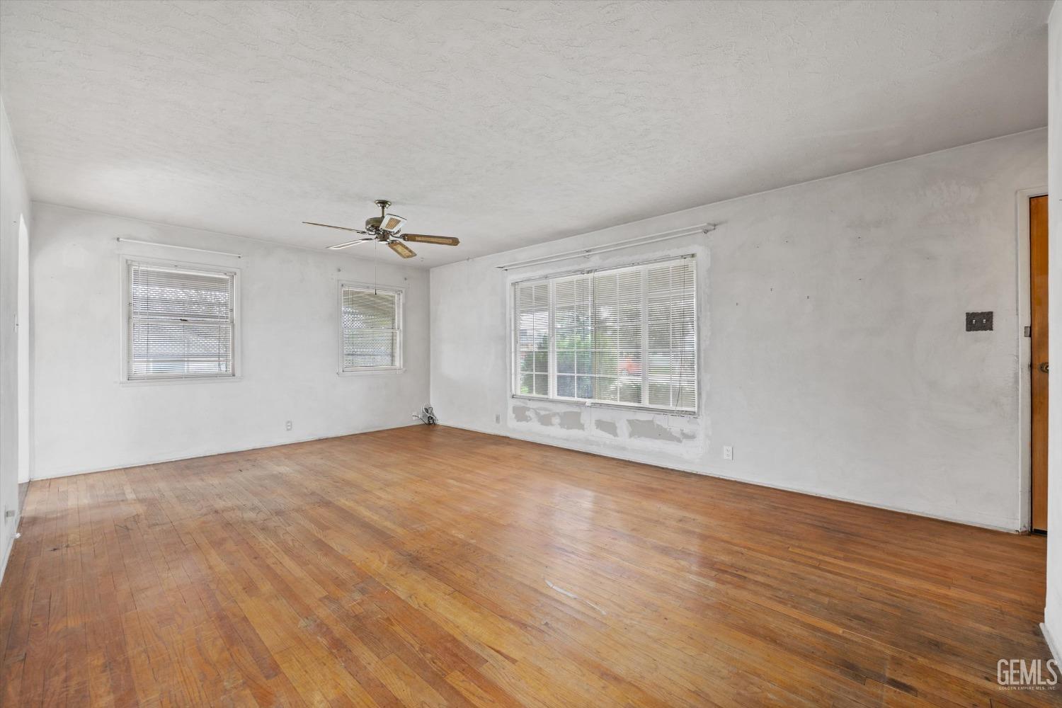 Undisclosed Address Bakersfield, CA 93308 - Photo 10 of 50 a view of an empty room with wooden floor and a window