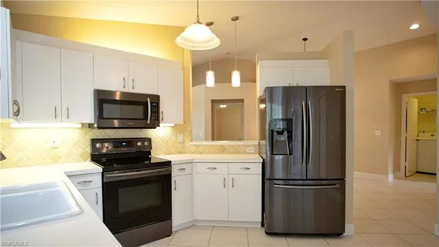 a kitchen with stainless steel appliances a refrigerator stove and microwave