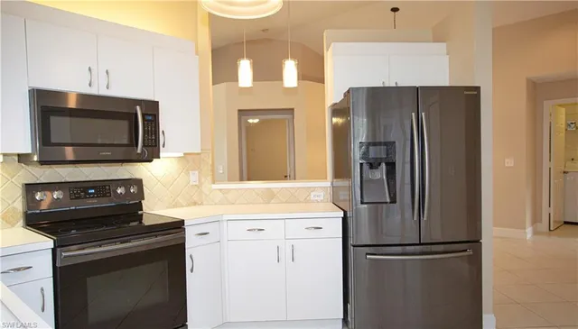 a kitchen with a refrigerator and a sink