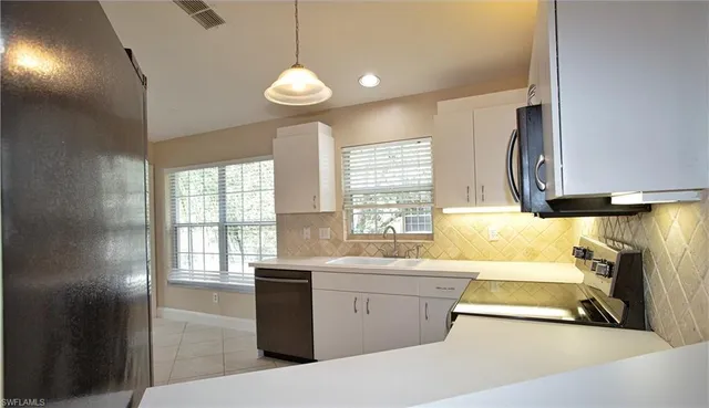 a view of a kitchen with a sink and a window