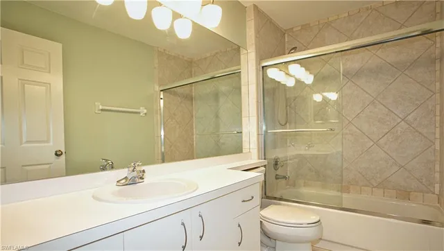 an empty room with a window and a chandelier fan