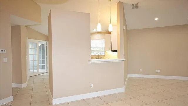 a view of an empty room with a window