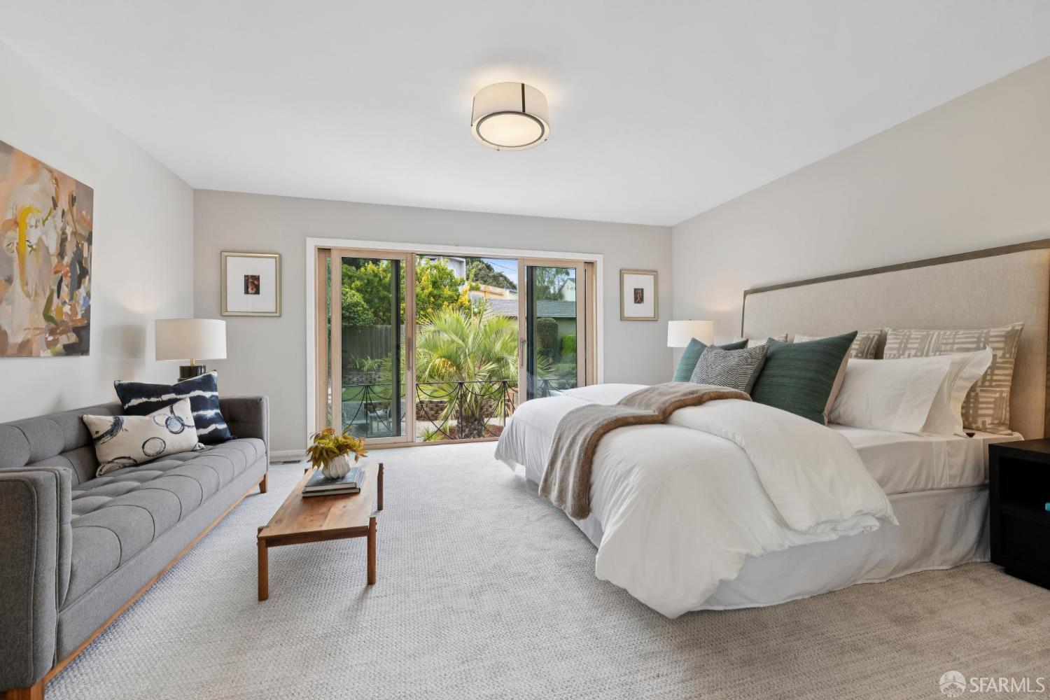 1983 10th Avenue San Francisco, CA 94116 - Photo 22 of 32 a spacious bedroom with a bed and a couch