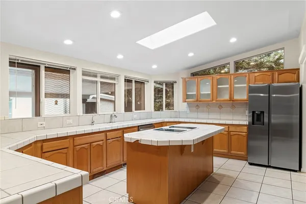 a kitchen with stainless steel appliances kitchen island granite countertop a stove and a refrigerator