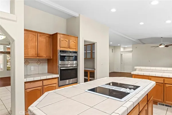 a kitchen with stainless steel appliances kitchen island granite countertop a stove and a refrigerator