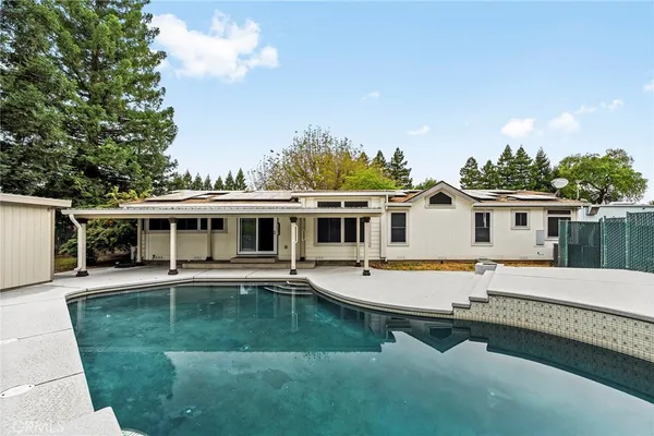 a view of a house with pool yard and a house