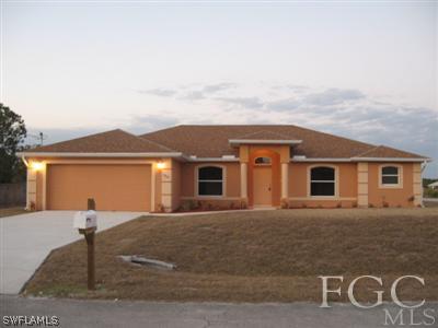 1900 West 13th Street Lehigh Acres, FL 33972 - Photo 1 of 10 a front view of a house with yard