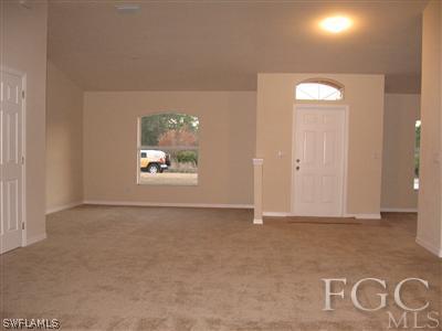 1900 West 13th Street Lehigh Acres, FL 33972 - Photo 6 of 10 an empty room with windows and closet