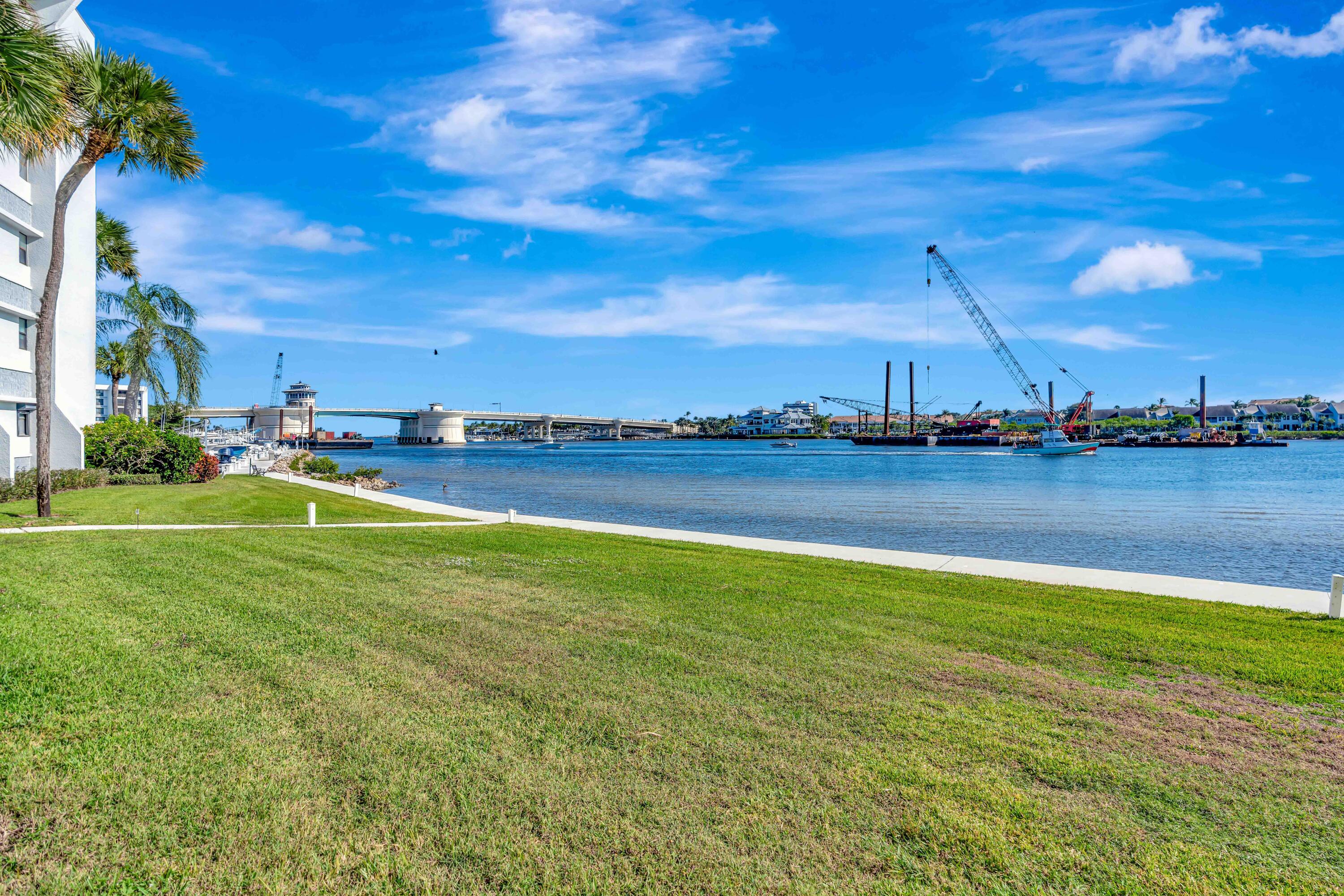 1542 Jupiter Cove Drive, Unit 104 Jupiter, FL 33469 - Photo 1 of 65 a view of a lake with houses in the back