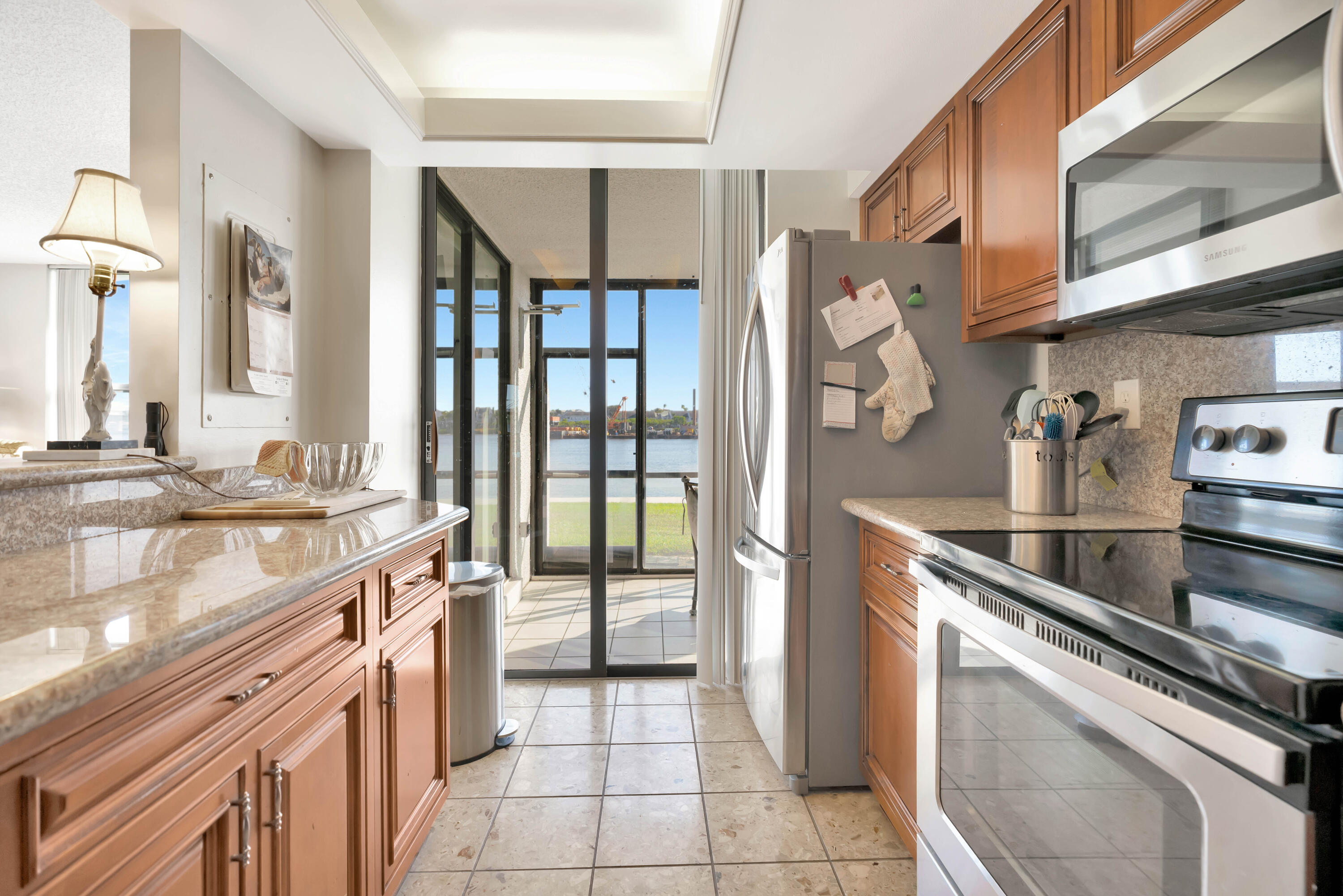 1542 Jupiter Cove Drive, Unit 104 Jupiter, FL 33469 - Photo 17 of 65 a kitchen with a sink appliances and cabinets