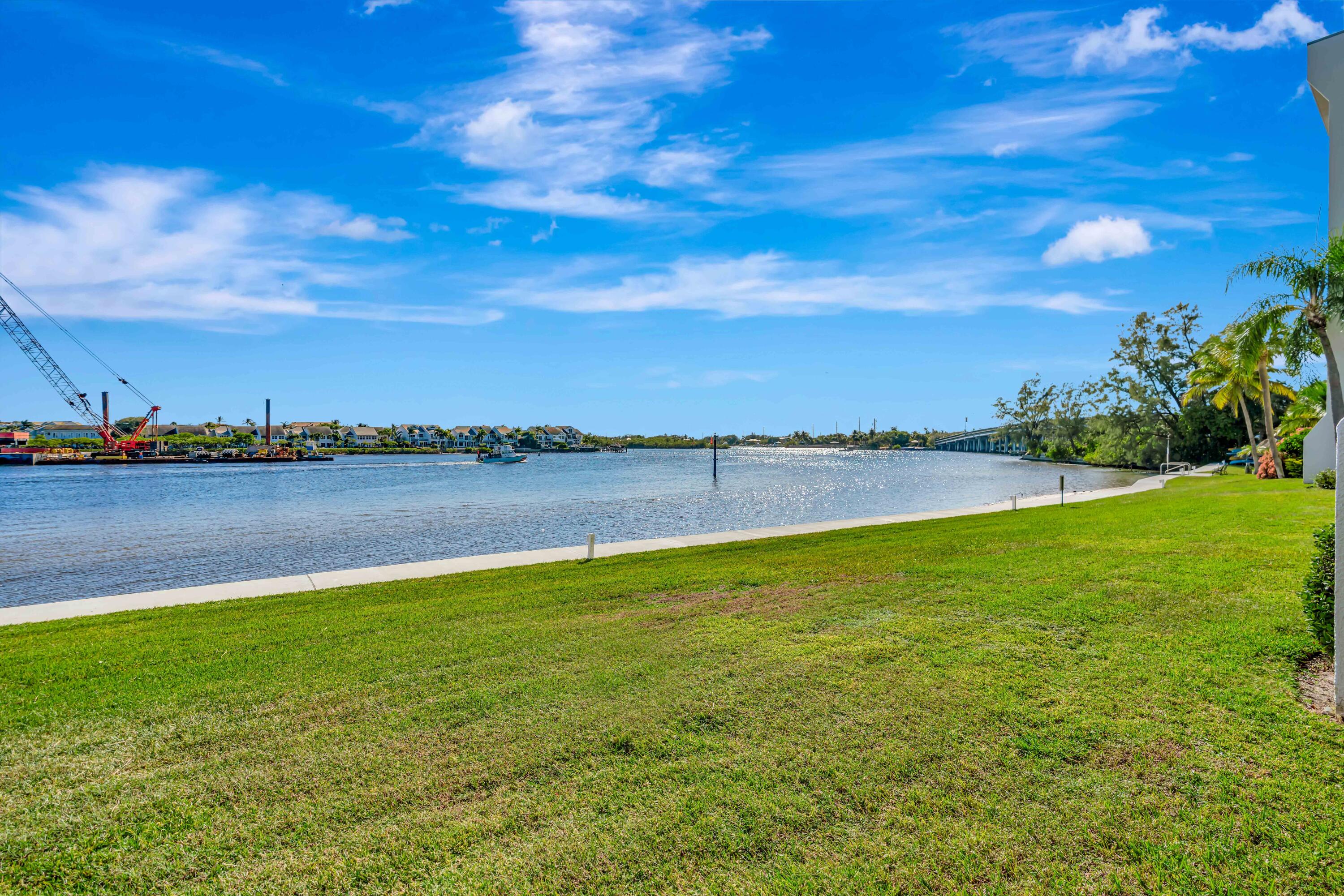 1542 Jupiter Cove Drive, Unit 104 Jupiter, FL 33469 - Photo 22 of 65 a view of a lake with houses in the back