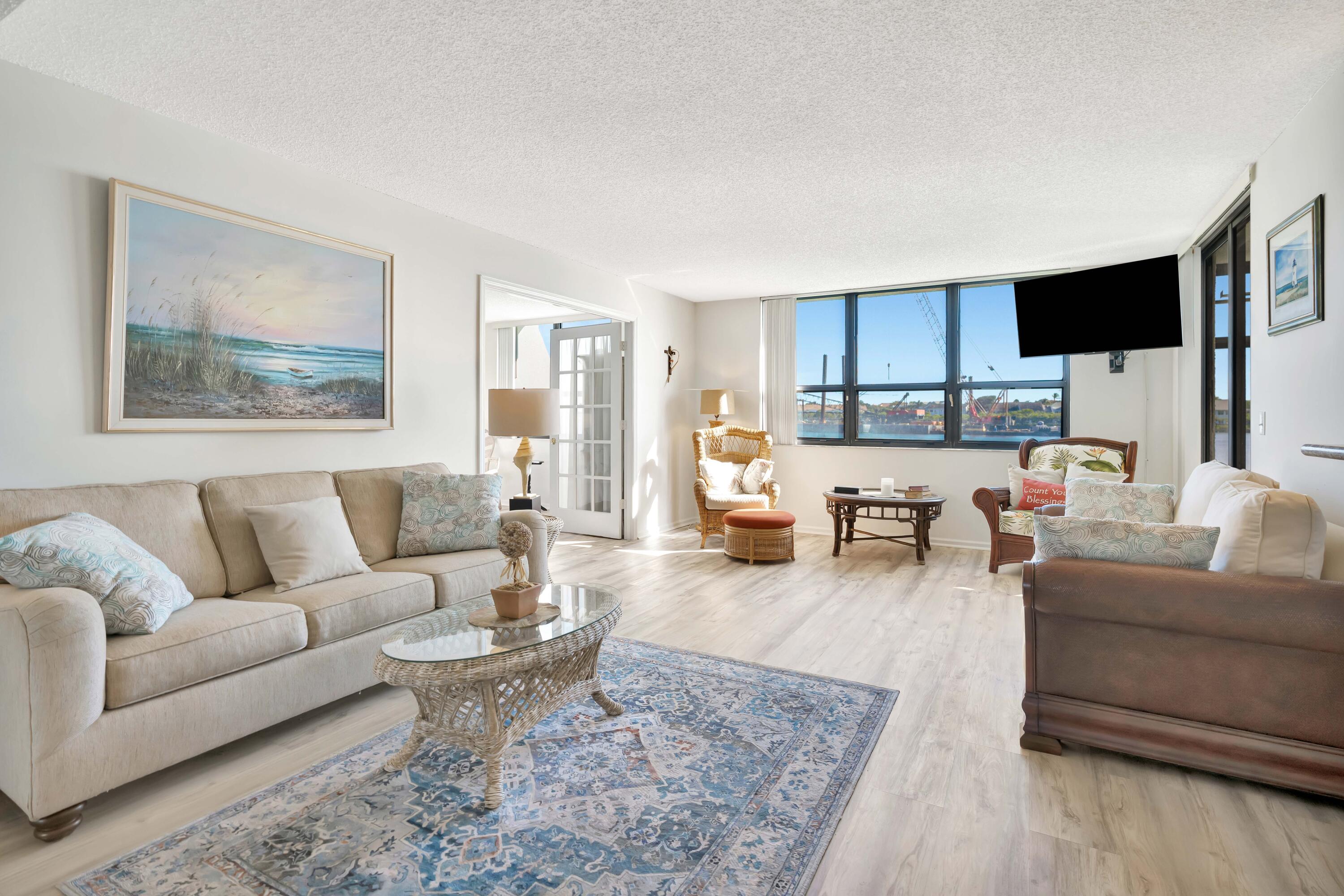 1542 Jupiter Cove Drive, Unit 104 Jupiter, FL 33469 - Photo 24 of 65 a living room with furniture or couch and a flat screen tv