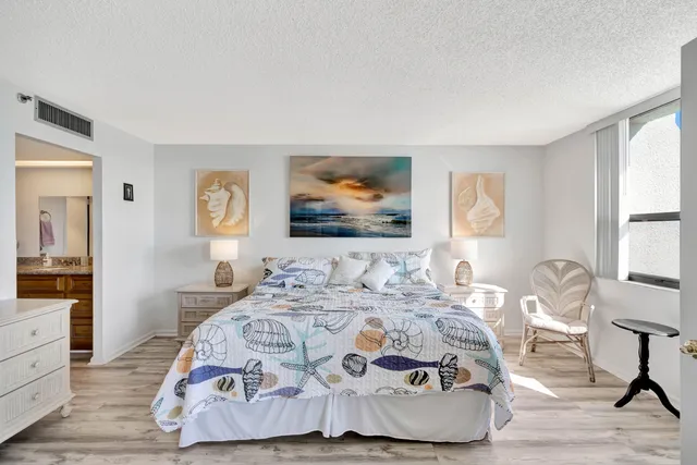 a bedroom with two beds and a chandelier